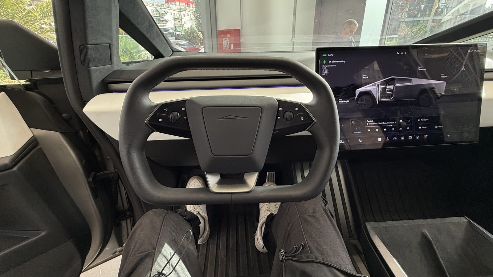 Driver's footwell, floor mats and dashboard of a Tesla Cybertruck seen from the driver's seat