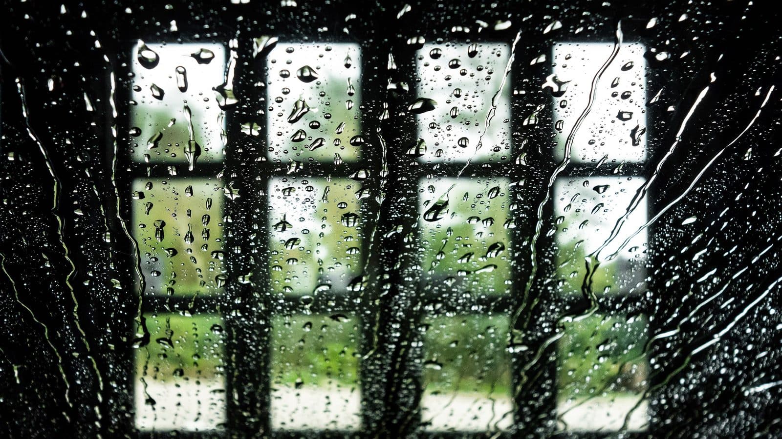 Water and soap streaming down a car window from inside an automatic car wash