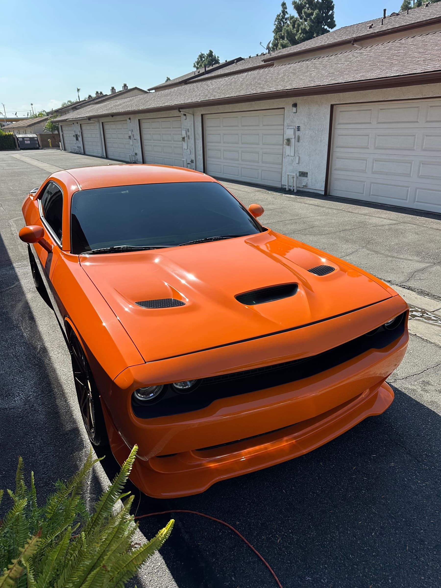 Finished mobile detail on an orange Dodge Challenger in a residential driveway