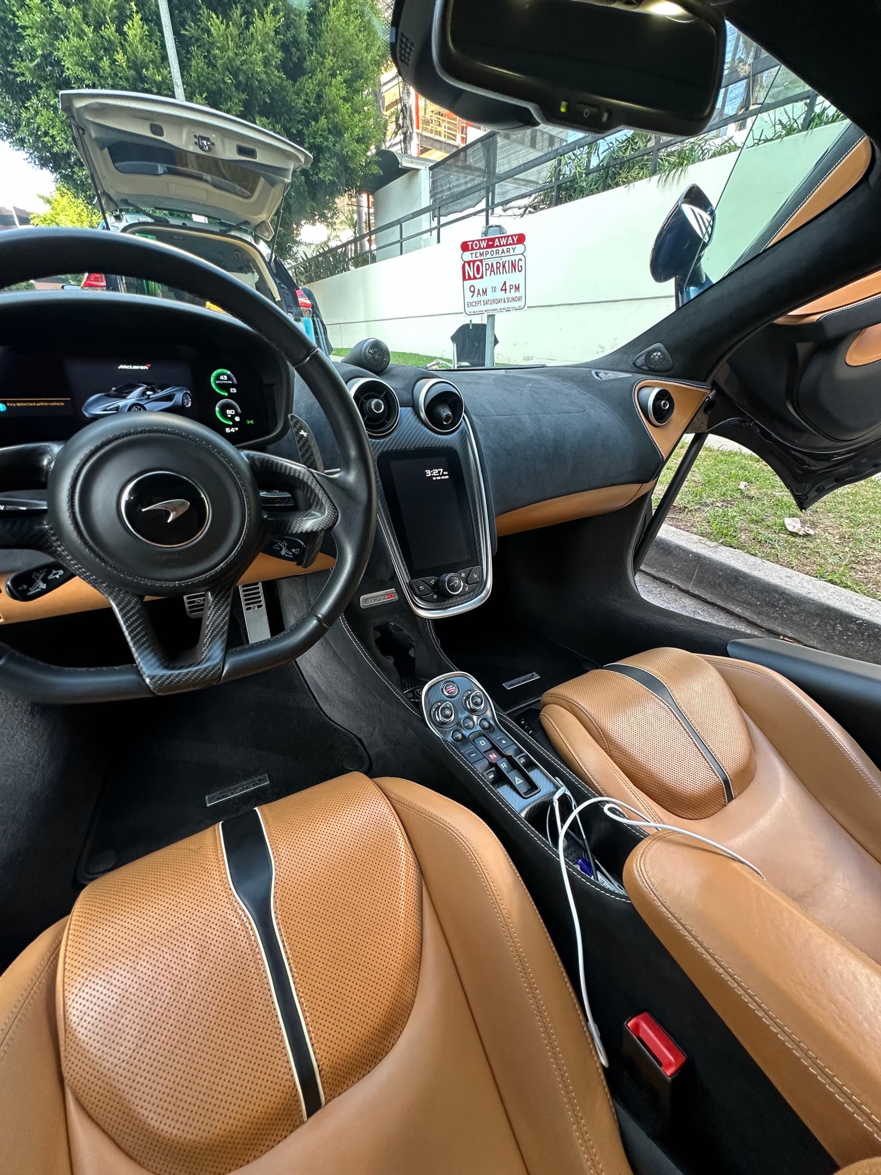 Interior detail on a McLaren showing clean tan leather seats and dashboard