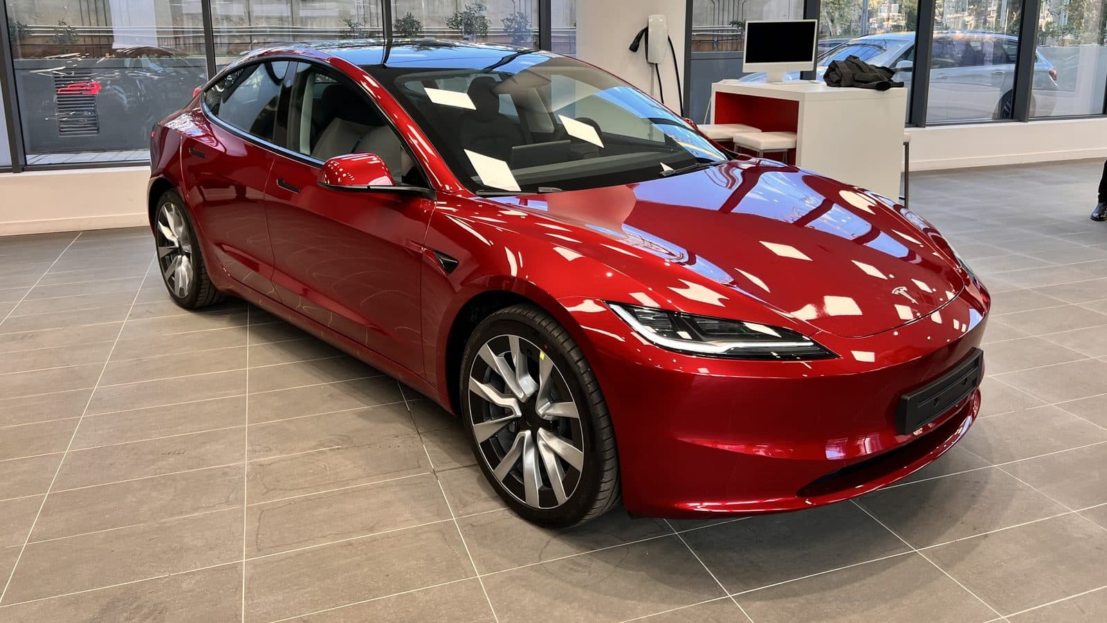5-year vs. 7-year ceramic coating in Los Angeles Glossy red Tesla Model 3 with a deep, reflective paint finish, the long-term gloss a 5-year or 7-year ceramic coating protects