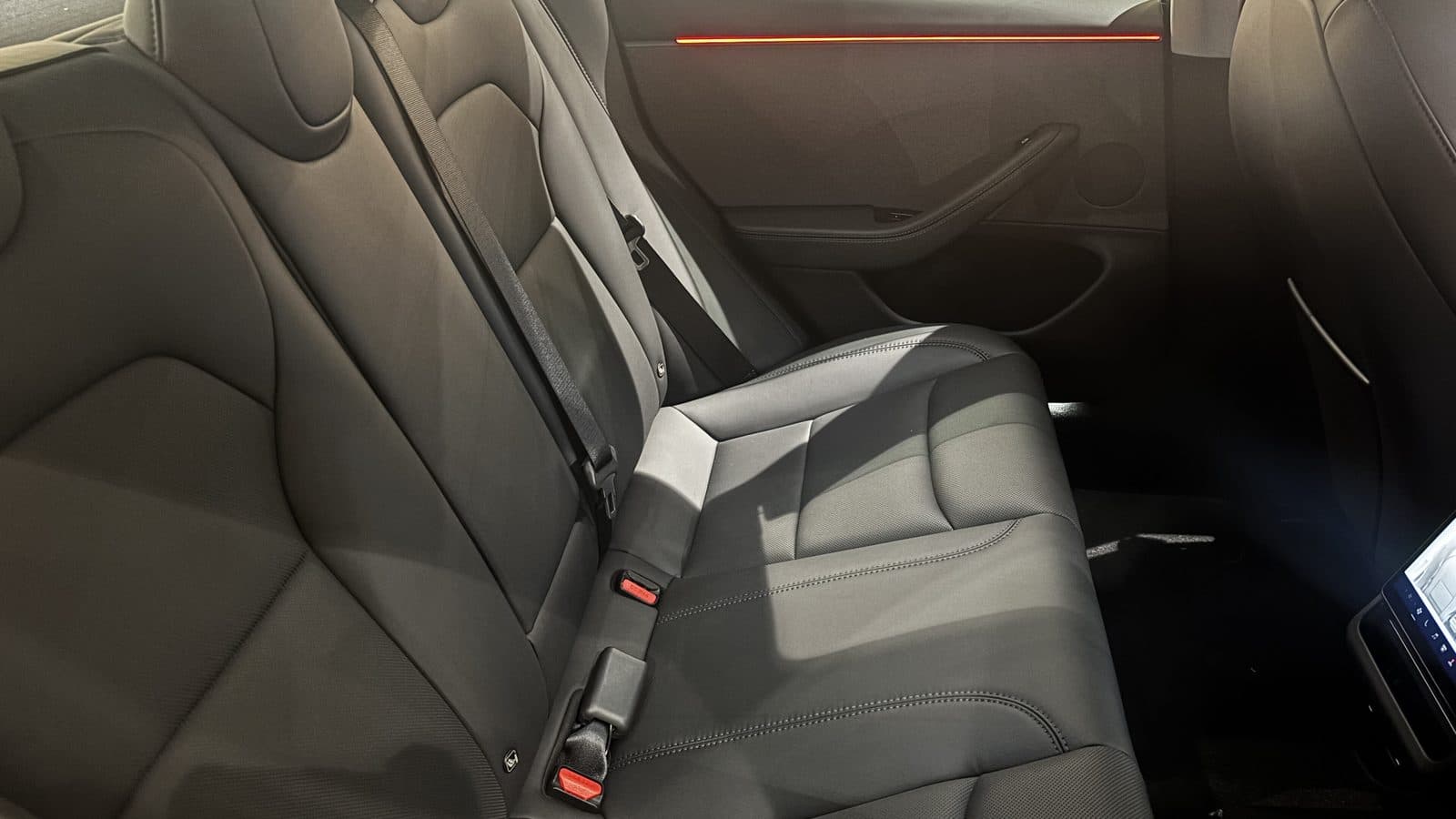 How to keep leather car seats cool in summer Close-up of black seats in a Tesla Model 3, the dark upholstery that gets hottest in summer sun