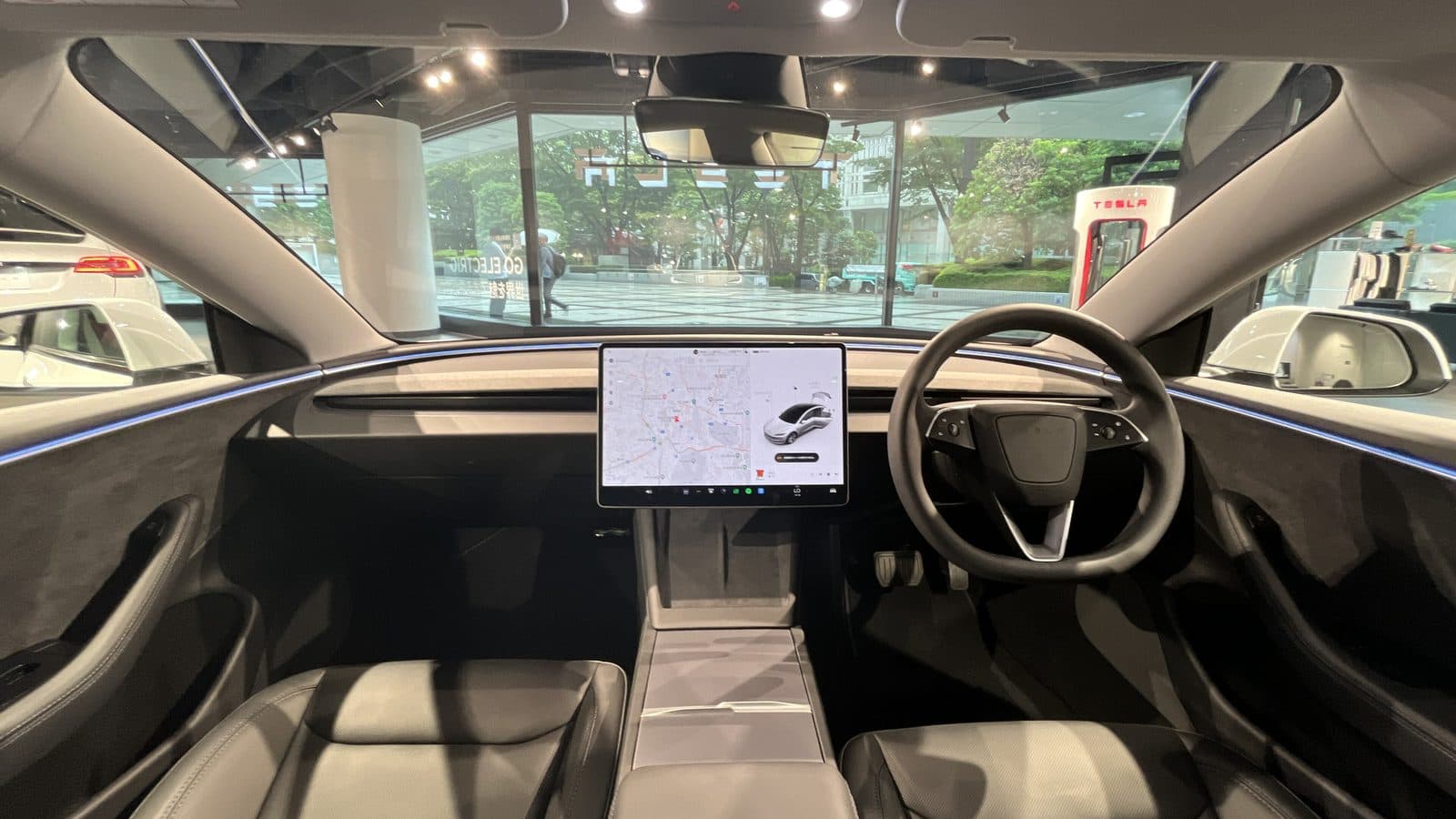 How to protect leather car seats from sun damage Tesla Model 3 interior with black seats, dashboard and touchscreen under a full glass roof letting in daylight