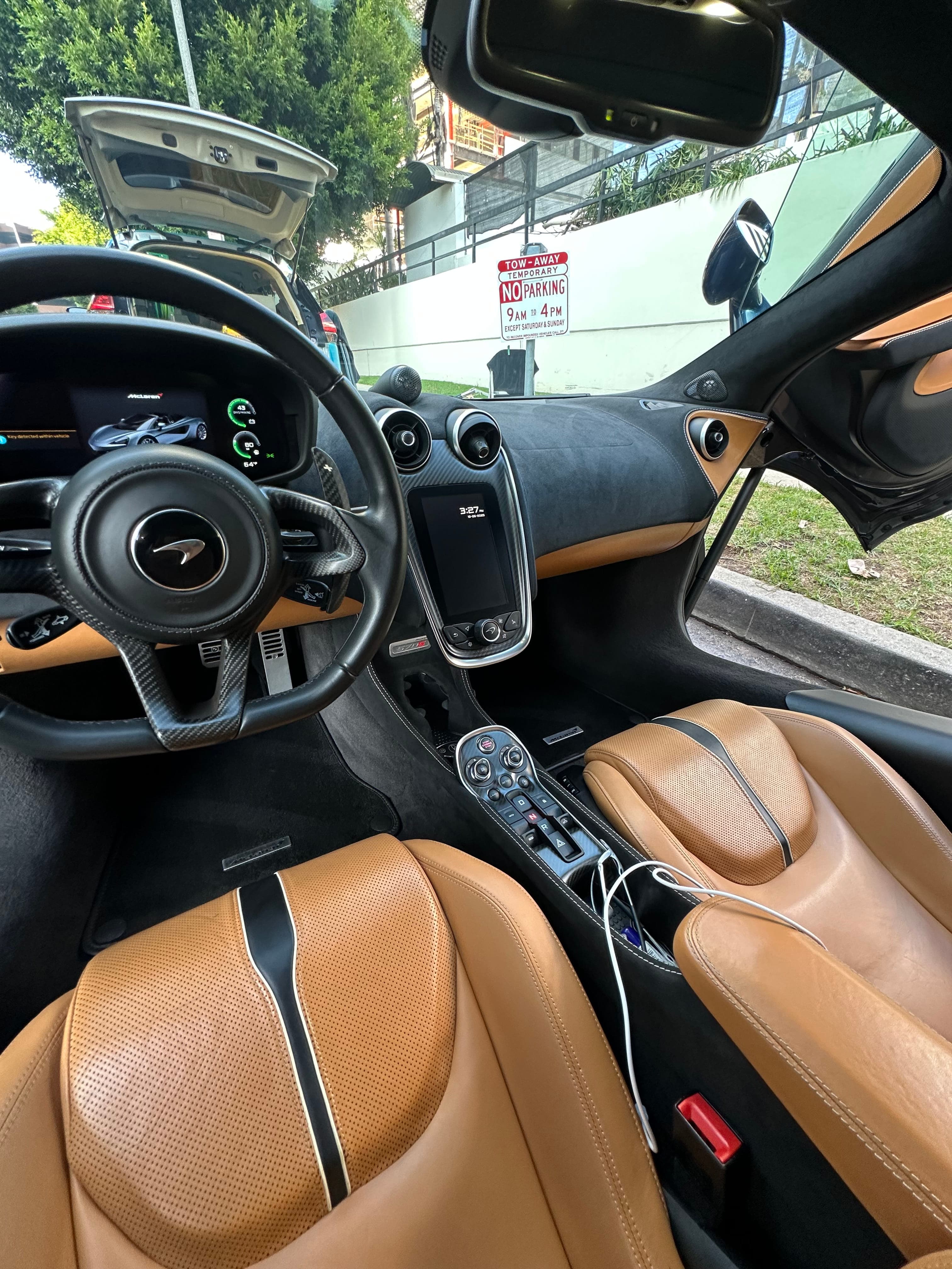 Interior detail on a McLaren showing clean tan leather seats and dashboard